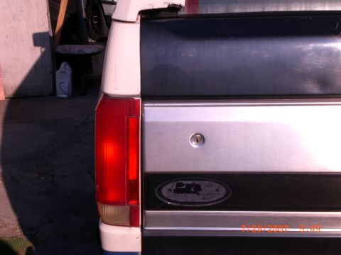 1991 Ford Bronco - Close-up of the rear of a 1991 Ford Bronco, showing the taillight and emblem.