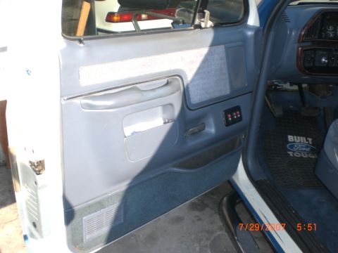 1991 Ford Bronco - Close-up of the driver's side interior door panel and dashboard of a Ford truck.