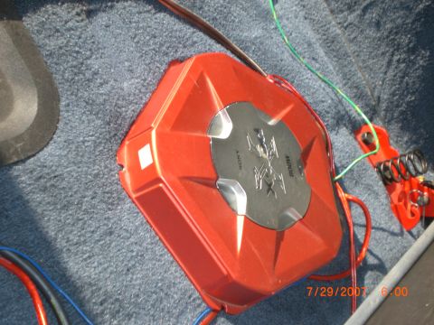 1991 Ford Bronco - A red car amplifier with visible wiring is shown on a carpeted surface.
