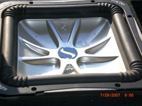 1991 Ford Bronco - Close-up of a car speaker, likely a Kicker brand, with a silver cone and prominent branding visible.