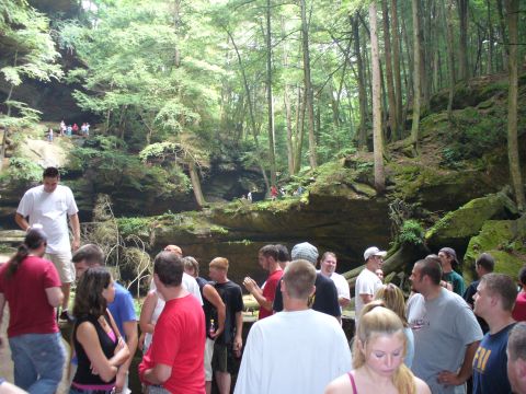 1991 Ford Probe - People gather in a lush, green canyon with rocky cliffs and tall trees.
