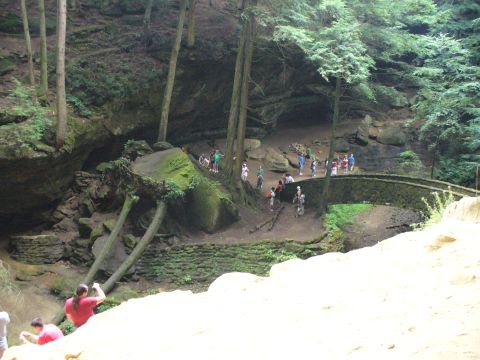 1991 Ford Probe - People explore a scenic gorge with a stone bridge and lush greenery.