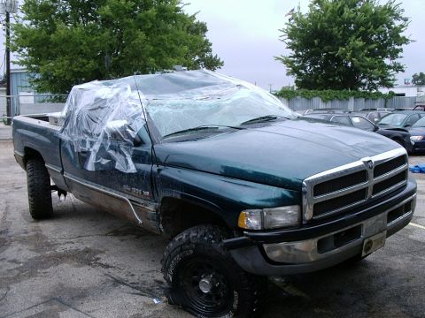 1996 Ford Bronco - This Dodge Ram pickup truck has a flat tire and its windshield is covered with plastic sheeting.