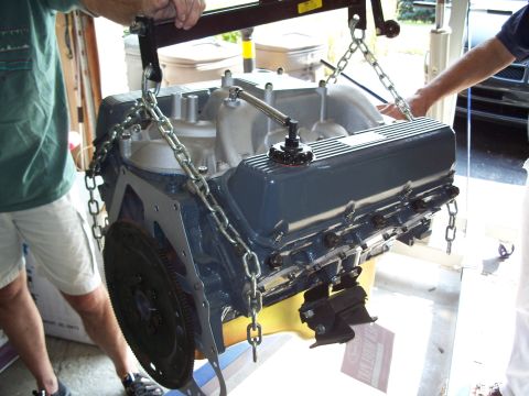1971 Ford Ranchero - A V8 engine is suspended by chains and a hoist, ready for installation or removal.