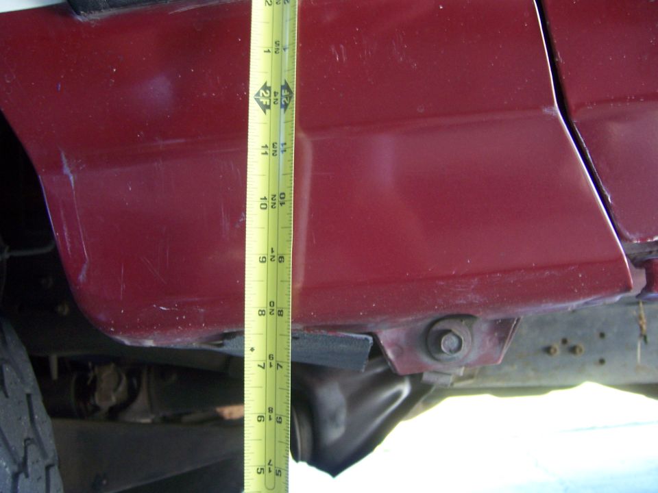 Measuring tape against the side body panel of a 1991 Ford Bronco