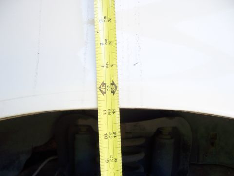 1991 Ford Bronco - Measuring the fender gap of a vehicle's suspension system.
