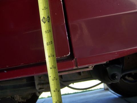 1991 Ford Bronco - Measuring tape is used to check clearance on the side of a vehicle's body panel.