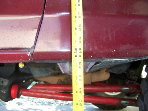 1991 Ford Bronco - Measuring suspension lift kit components on a vehicle.