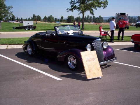 1972 Ford Ranchero - This custom hot rod convertible is displayed at an outdoor event with a wooden sign in front.