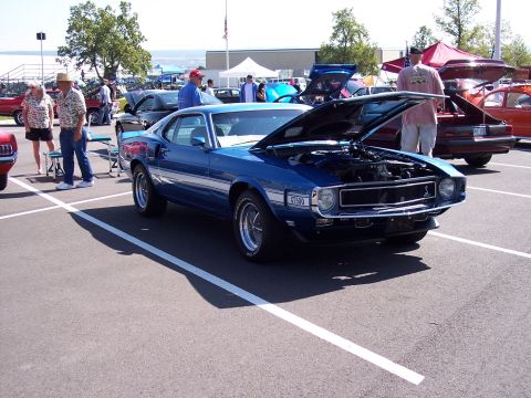 1972 Ford Ranchero - A blue muscle car, possibly a 1970 model, is displayed with its hood open at an outdoor car show.