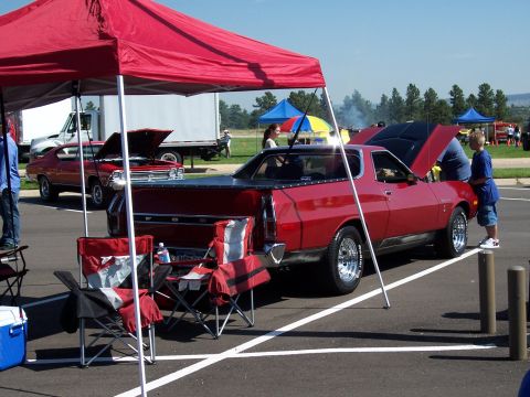 1972 Ford Ranchero - Red 1972 Ford Ranchero pickup truck with hood open at an outdoor event.