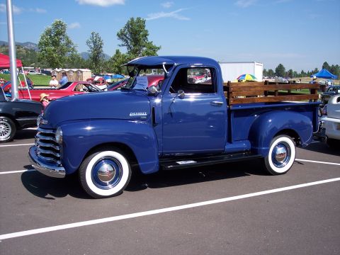 1972 Ford Ranchero - A classic blue Chevrolet pickup truck is parked in a lot on a sunny day.
