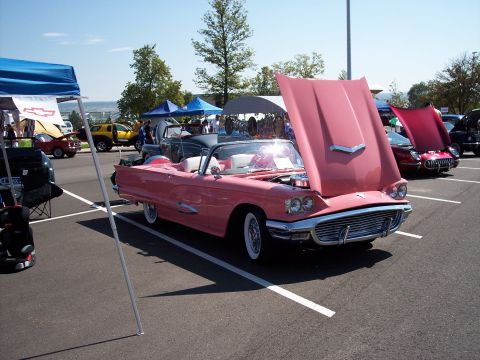 1972 Ford Ranchero - A pink 1959 Ford Thunderbird convertible is displayed with its hood open at an outdoor car show.