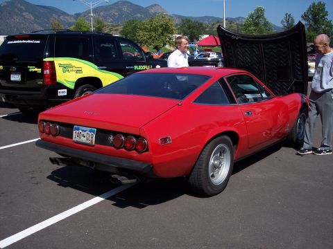 1972 Ford Ranchero - Rear view of a red Ferrari 365 GT4 2+2 at an outdoor car show.