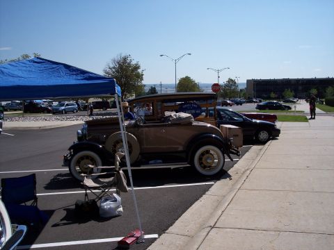 1972 Ford Ranchero - A vintage coupe with a wooden bed is parked at an outdoor event next to newer vehicles.