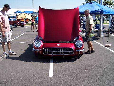 1972 Ford Ranchero - A red 1955 Chevrolet Corvette is displayed with its hood open at a car show.
