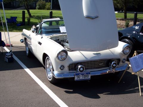 1972 Ford Ranchero - A white 1956 Ford Thunderbird convertible is displayed with its hood open, parked next to another vehicle.