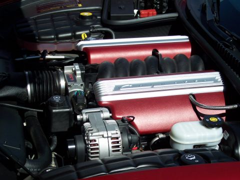 1972 Ford Ranchero - The engine bay of a car, red painted valve covers and various engine components.