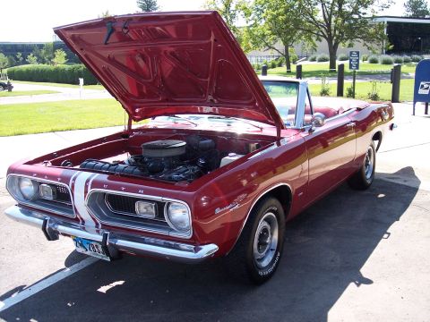 1972 Ford Ranchero - 1967 Plymouth Barracuda convertible with its hood open, revealing the engine bay.