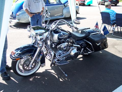 1972 Ford Ranchero - A custom Harley Davidson motorcycle is parked next to classic cars.