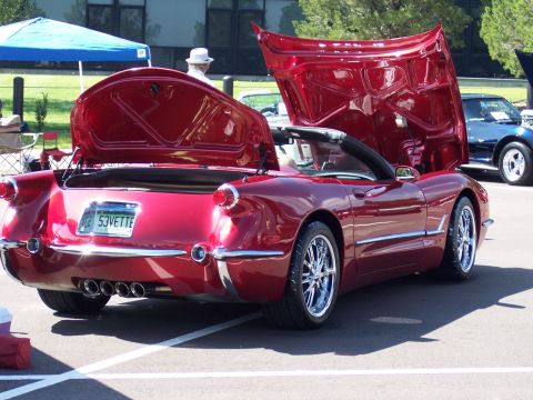 1972 Ford Ranchero - Red 1953 Corvette convertible, hoods open, parked outdoors with another vehicle in the background.