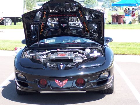 1972 Ford Ranchero - Front view of a black Pontiac Firebird with its hood open, revealing the engine bay.