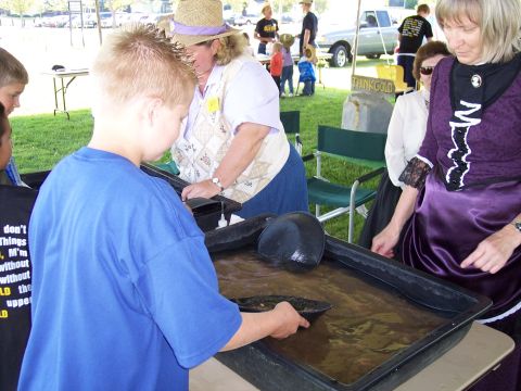 1972 Ford Ranchero - People try their hand at gold panning, with a pickup truck visible in the background.