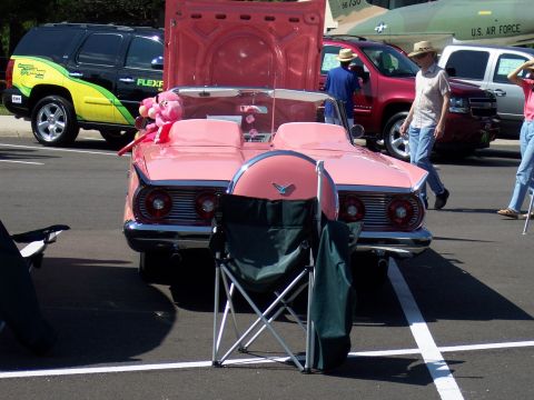 1972 Ford Ranchero - A pink convertible, likely a 1959 model, is displayed with its hood open, accompanied by a pink stuffed animal on the passenger seat.