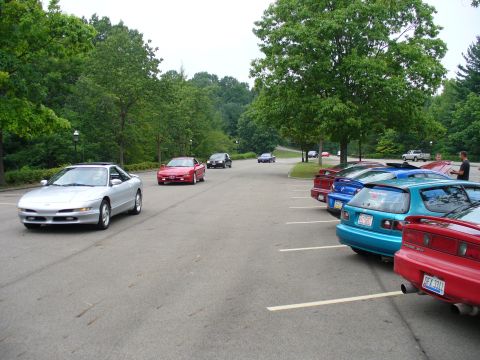 1991 Ford Probe - A silver 1991 Ford Probe is seen driving on a road with other vehicles in the background.