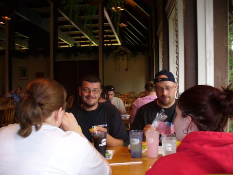 1991 Ford Probe - People gathered around a table at a restaurant, enjoying drinks and conversation.