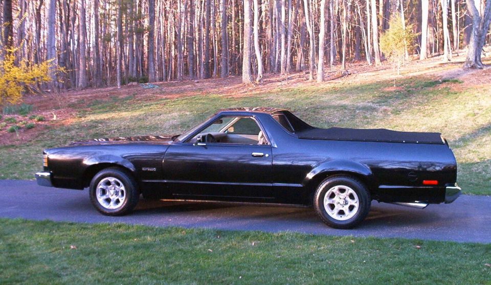Black coupe utility vehicle, side view