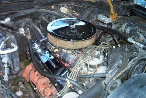 1990 Ford F-250 - Close-up view of an engine bay with various components and wiring visible.