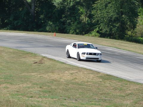 1993 Ford Taurus - White 2005 Ford Mustang seen on a road course, displaying race number 36.