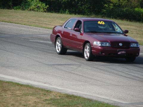 1993 Ford Taurus - This red sedan, likely a Mercury Marauder or similar model, is seen on a race track with the number 40 displayed.