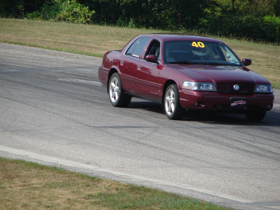 Red sedan with racing number 40 on windshield and SHO badge on grille