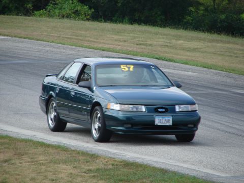 1993 Ford Taurus - Green 1993 Ford Taurus seen on a road course, displaying racing number 57.