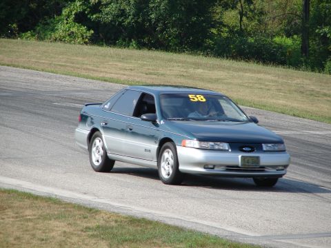1993 Ford Taurus - 1993 Ford Taurus on a road course, displaying racing number 58.