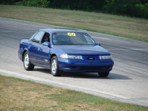 1993 Ford Taurus - A blue 1993 Ford Taurus is seen on a race track, displaying the number 60 on its windshield.