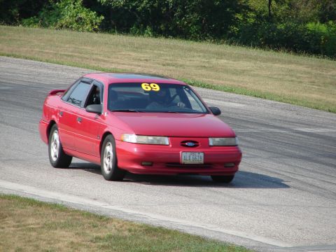 1993 Ford Taurus - This 1993 Ford Taurus is seen on a road course, displaying the number 69 on its windshield.