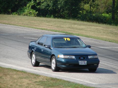 1993 Ford Taurus - This dark green 1993 Ford Taurus is on a race track, displaying the number 78.