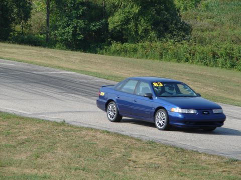 1993 Ford Taurus - Blue 1993 Ford Taurus on a racetrack, displaying racing number 83.