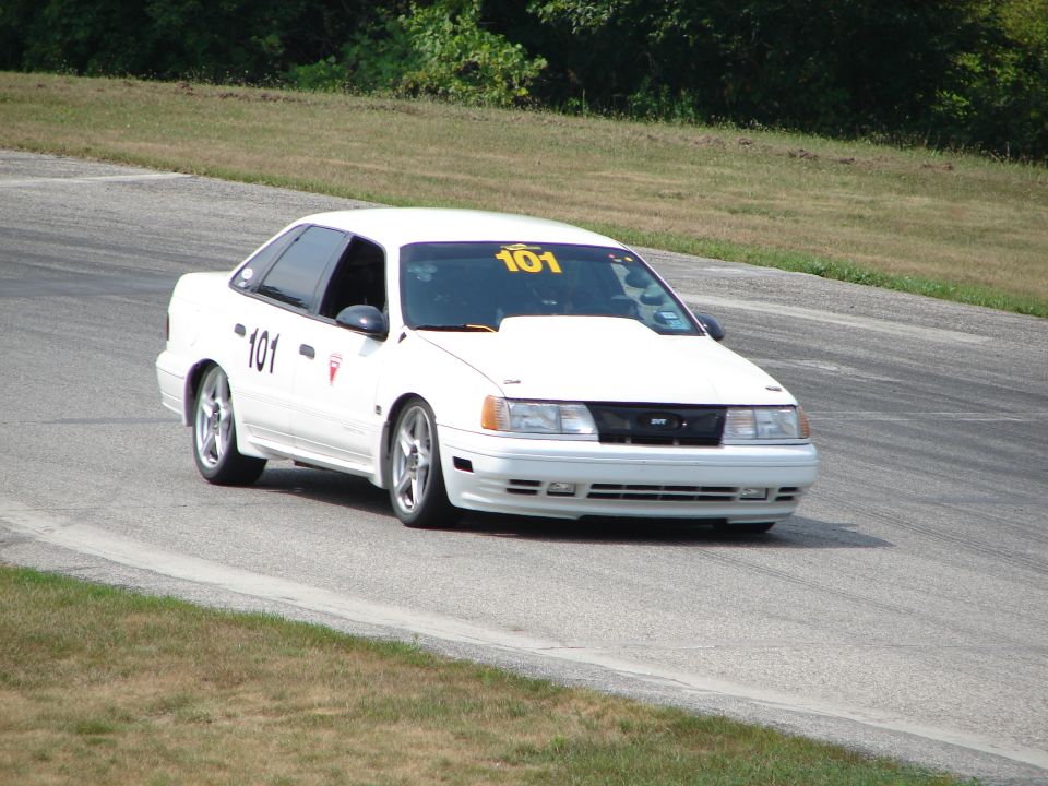 White 1993 Ford Taurus on track with number 101