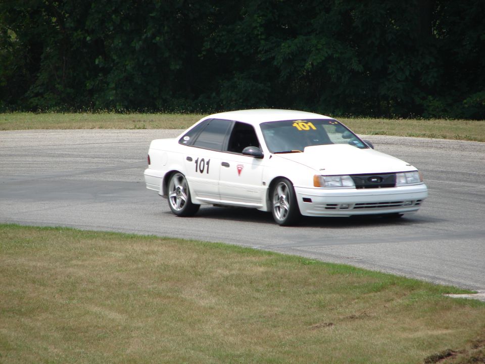 White 1993 Ford Taurus on track, number 101 on door and windshield