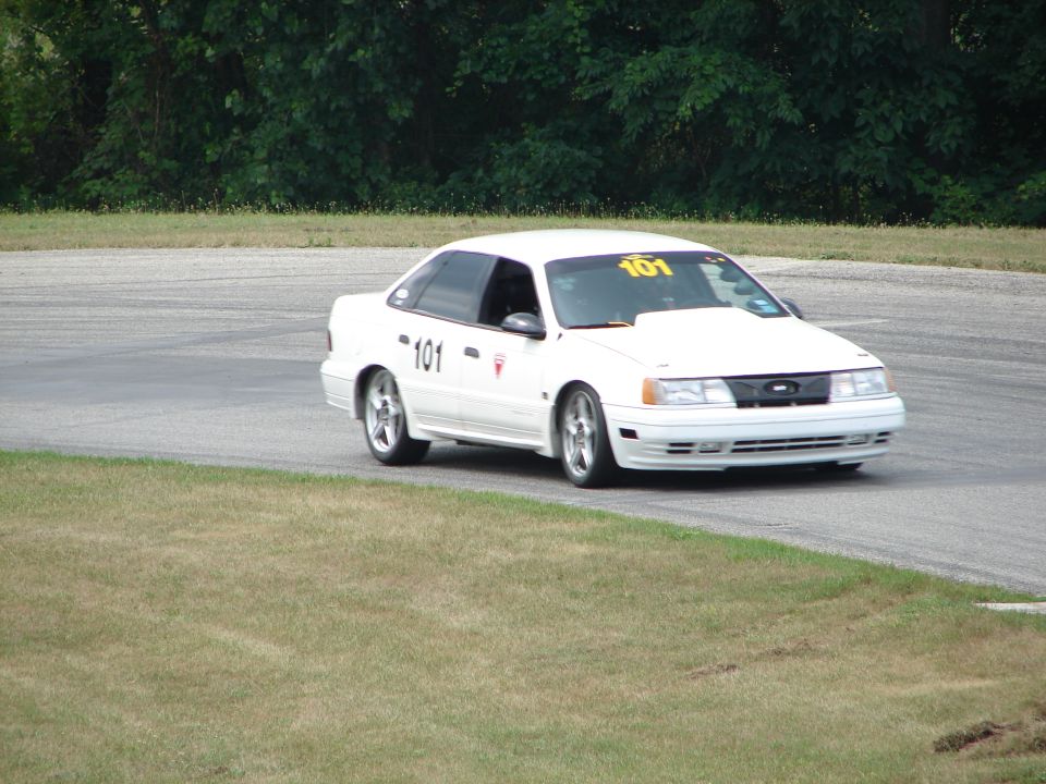 1993 Ford Taurus on a race track, number 101 on door and windshield