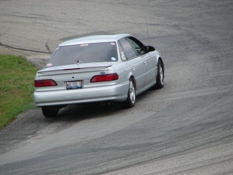 1993 Ford Taurus - Silver 1993 Ford Taurus navigates a turn on a race track.