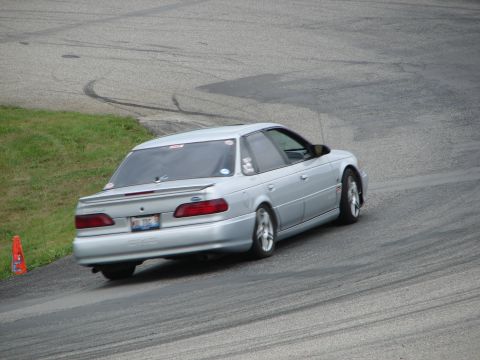 1993 Ford Taurus - Silver 1993 Ford Taurus seen on a racetrack, captured from the rear.