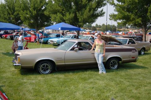 1967 Ford Ranchero - A 1972 Ford Ranchero is displayed at an outdoor car show with a woman posing beside it.