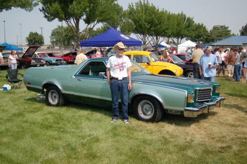 1967 Ford Ranchero - A man poses next to a mint green 1977 Ford Ranchero at the Northwest MotorFest.