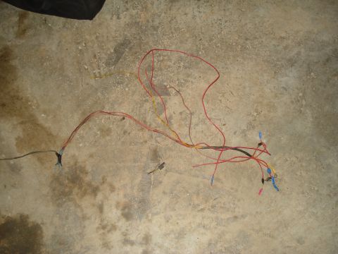 1967 Ford F-250 - A collection of vehicle wires and connectors are spread out on a concrete surface.