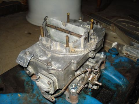 1967 Ford F-250 - A close-up view of a carburetor, a critical engine component for fuel and air mixture.